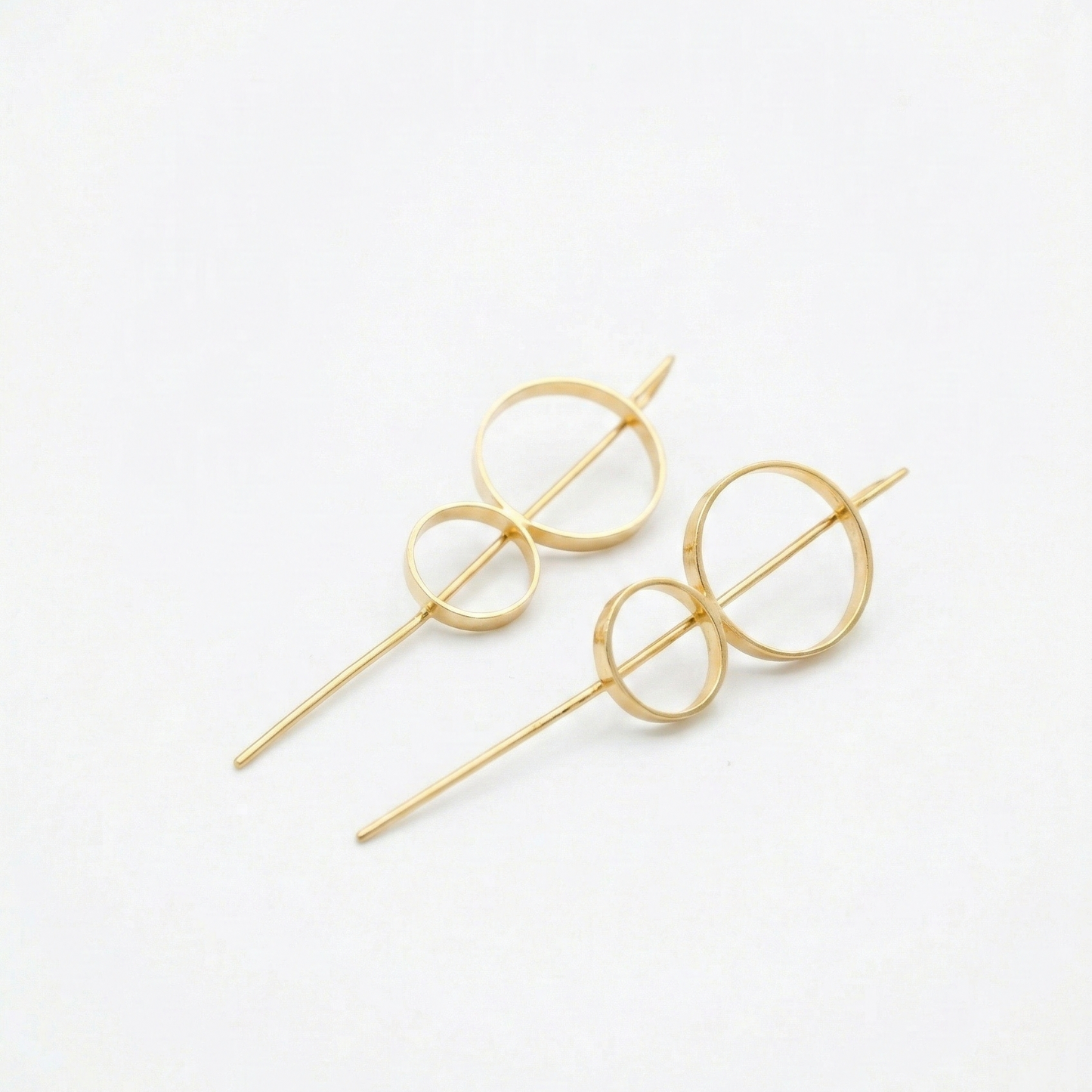 Gold 8 stick hoop earrings on a white background