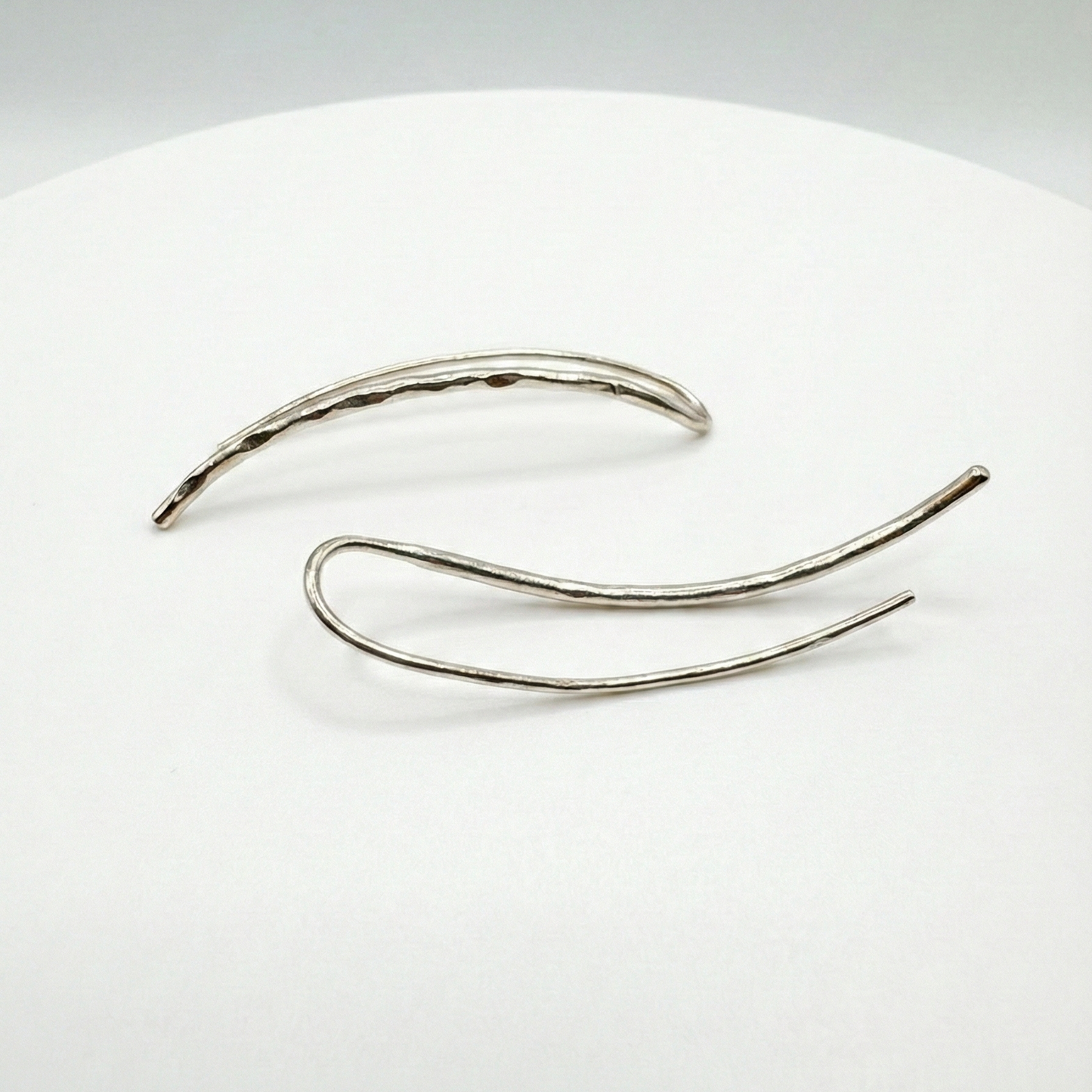 Silver earclimbers on a white background