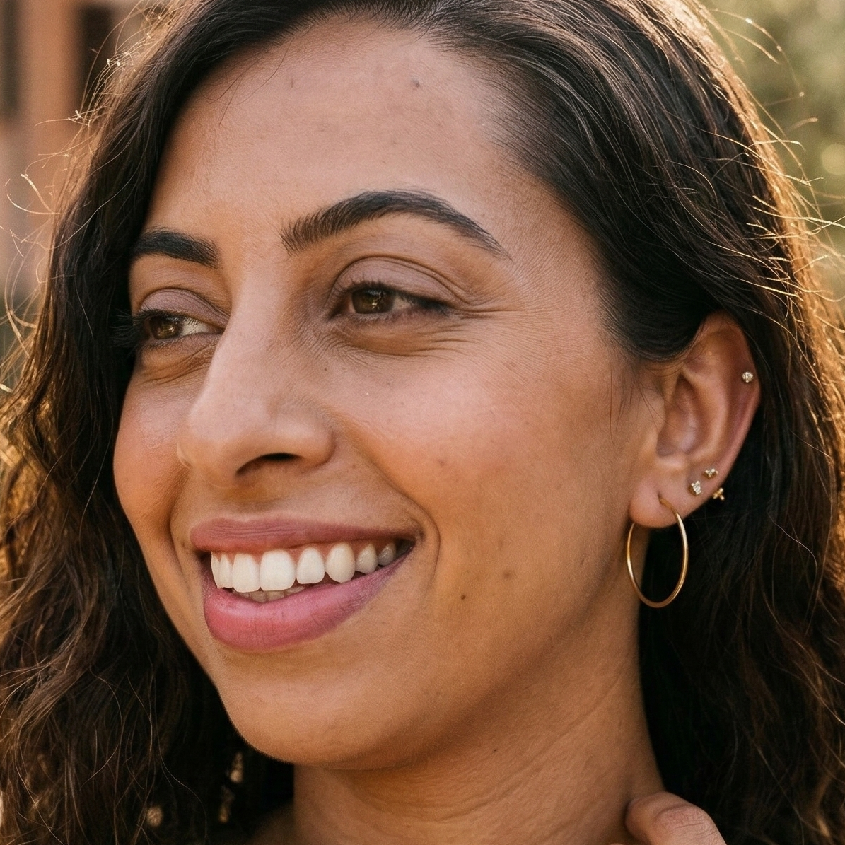 Woman wearing 30mm gold hoops