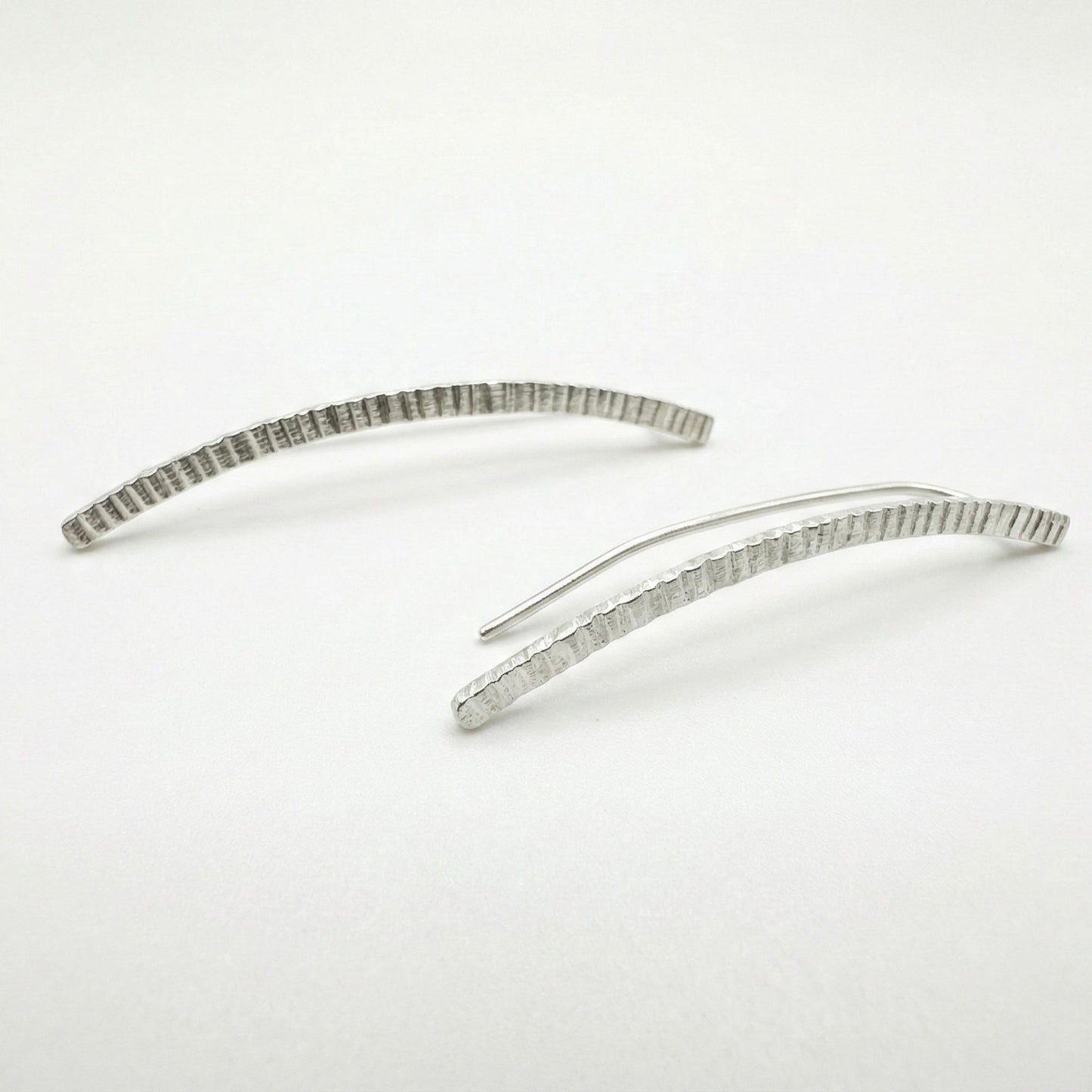 silver earclimbers on a white background