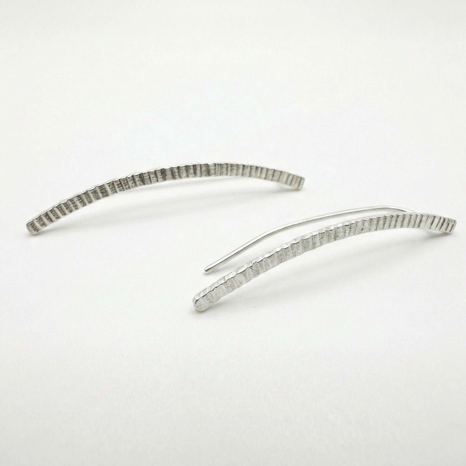 silver earclimbers on a white background