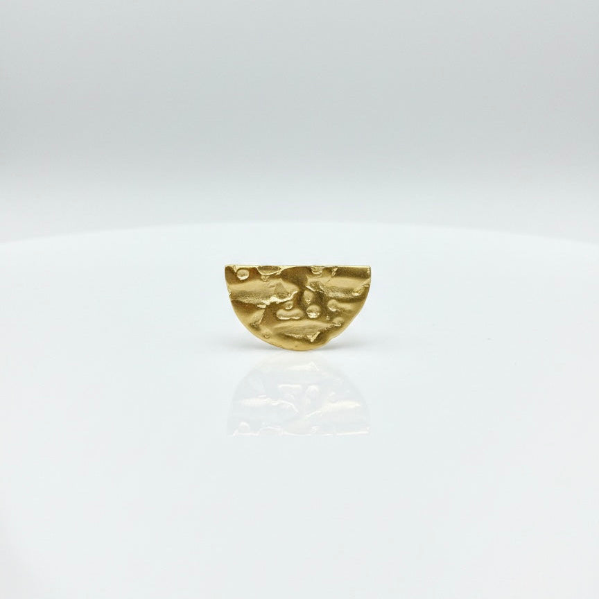 Gold brooch on a white background