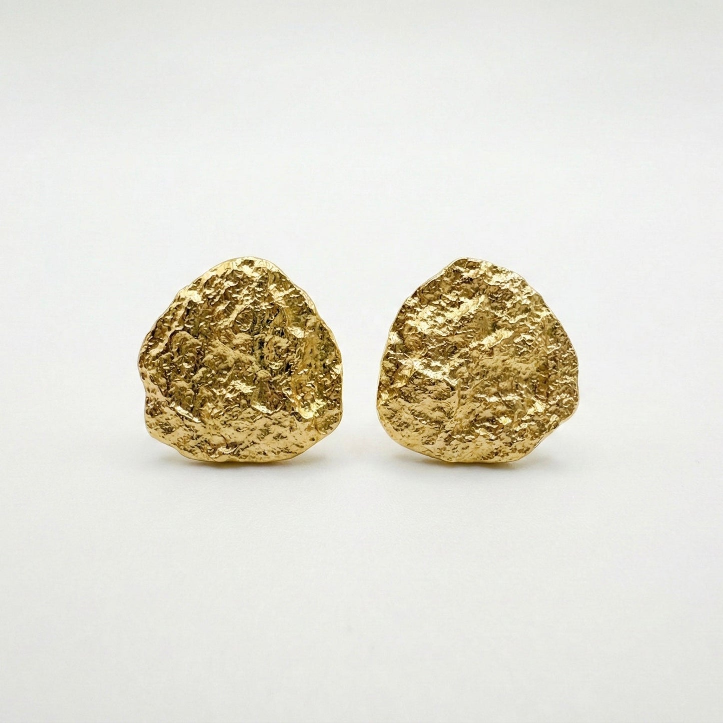 Pair of gold earrings on a white background