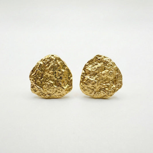 Pair of gold earrings on a white background