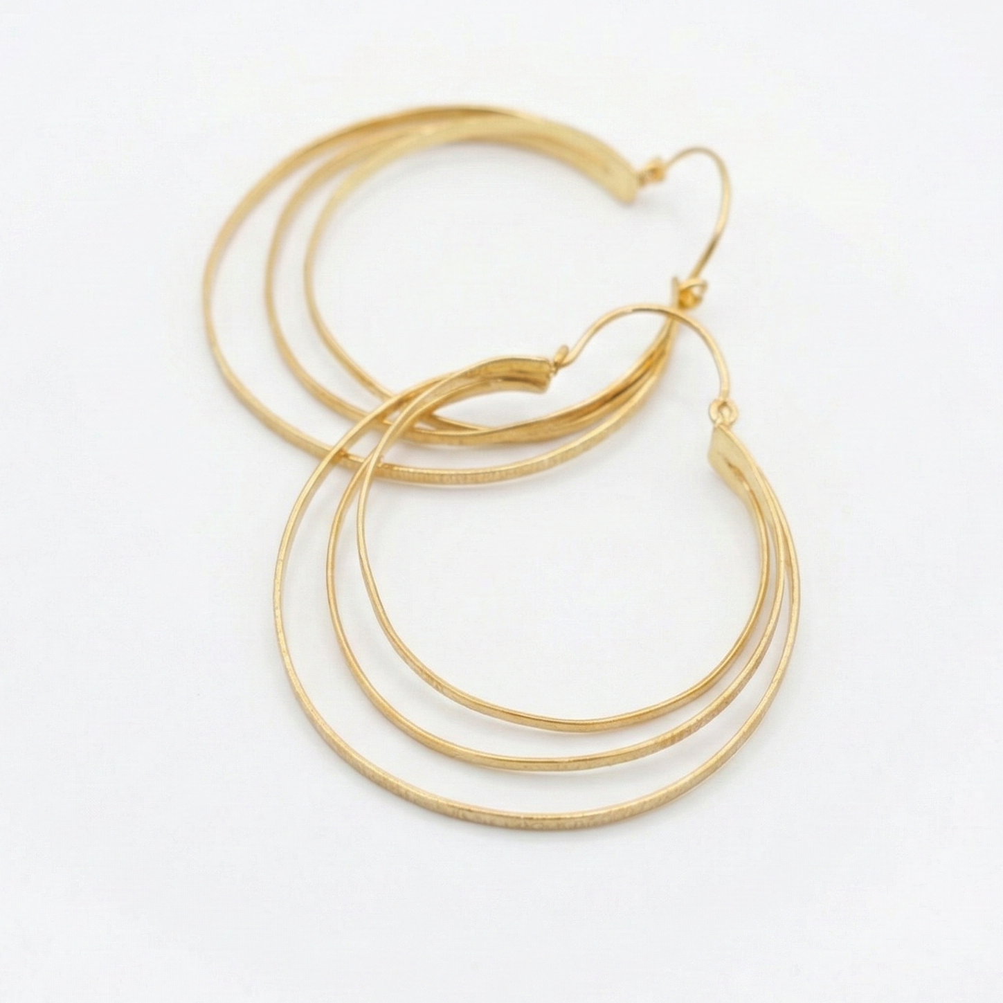 Gold hoop earrings on a white background