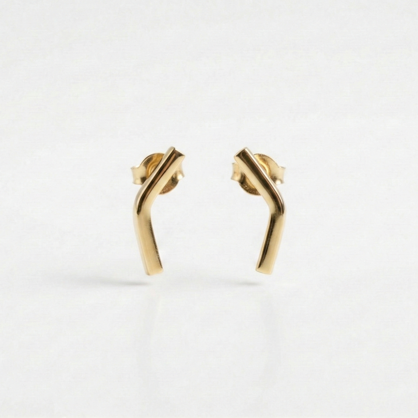 Gold earrings on a white background