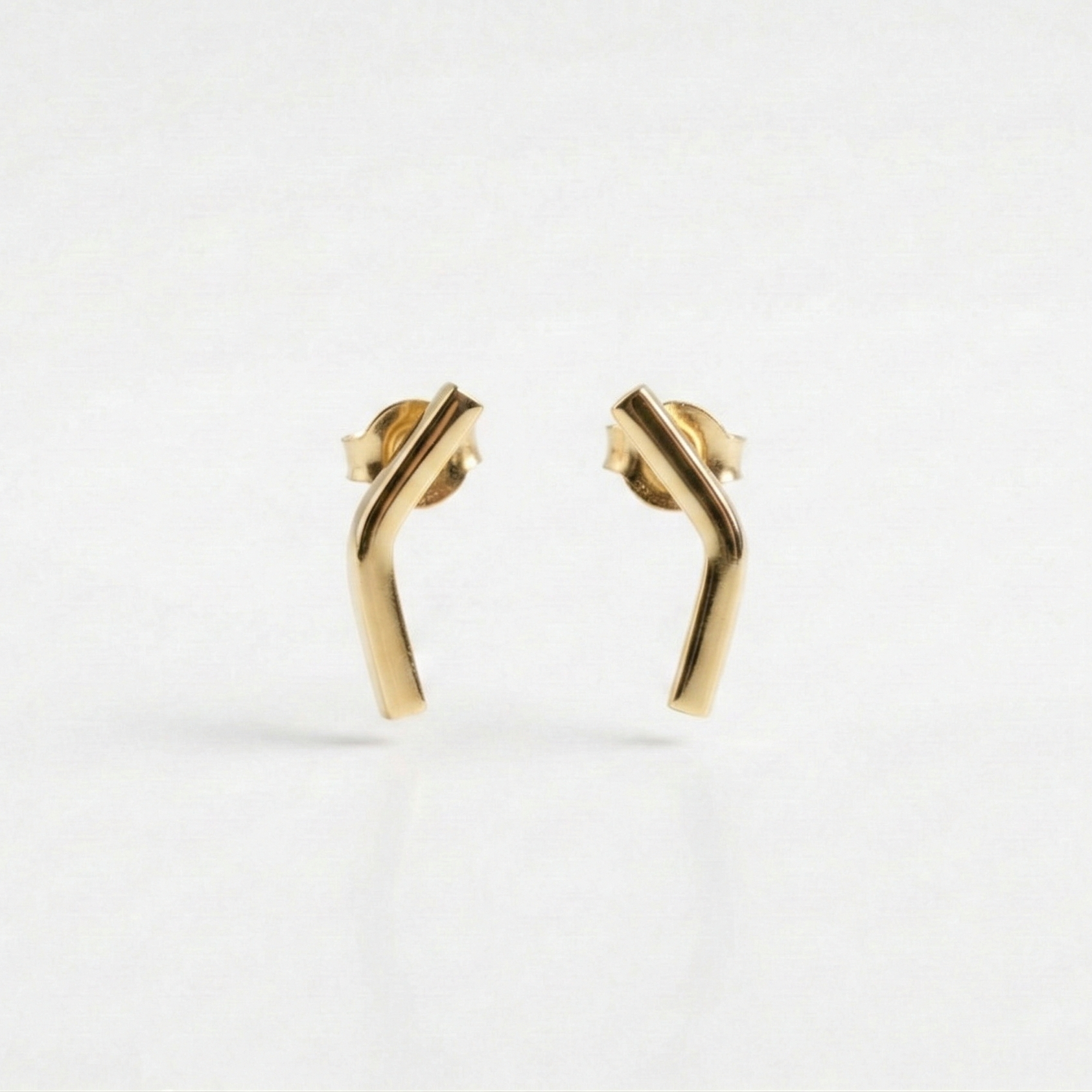 Gold earrings on a white background