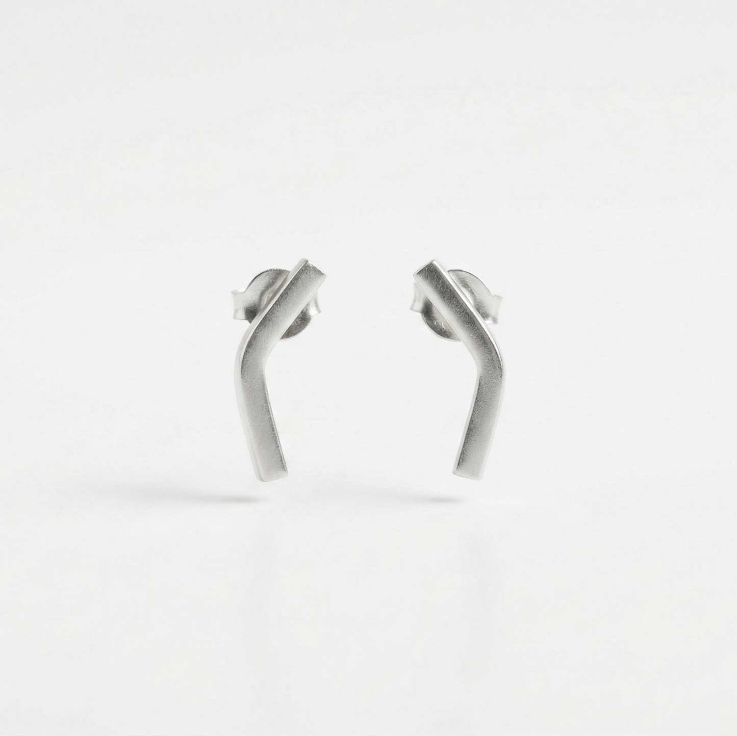 Pair of silver earrings on a white background