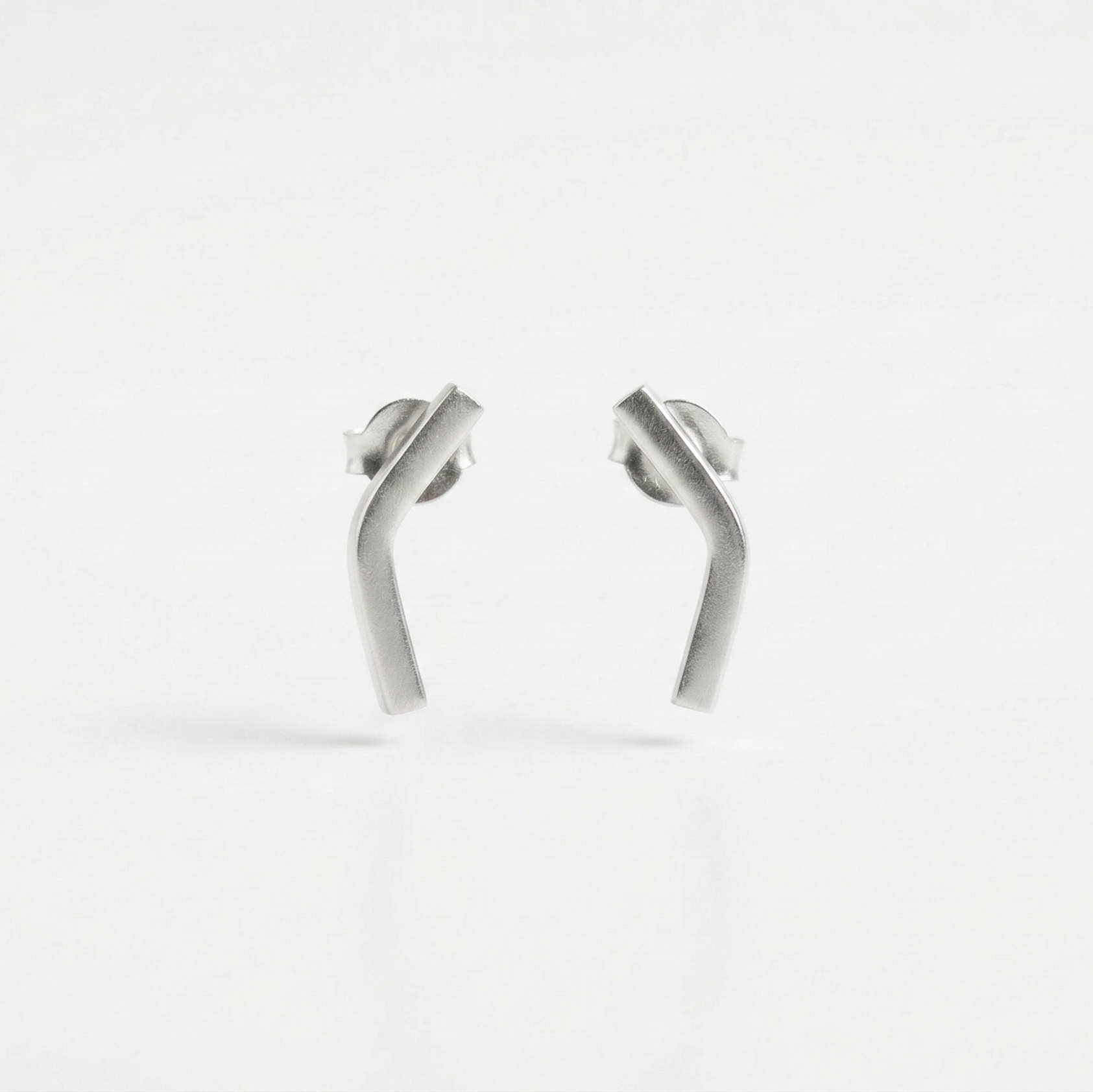 Pair of silver earrings on a white background