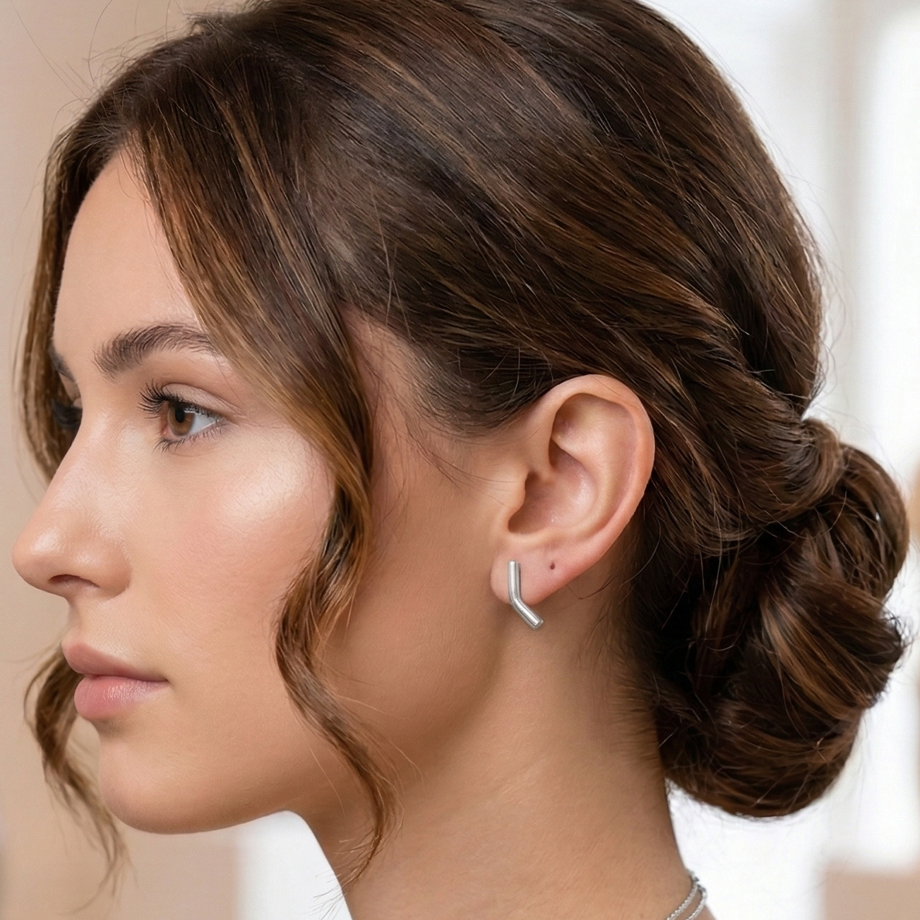 Woman wearing silver boomerang stud earrings