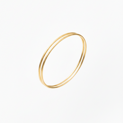 Gold bangle on a white background