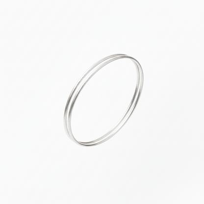 Silver bangles on a white background