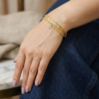 Gold bracelet on a wrist with a blurred background