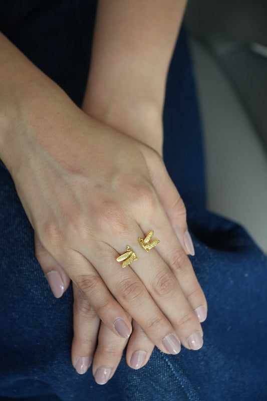 Close-up of hands wearing dragonfly ring