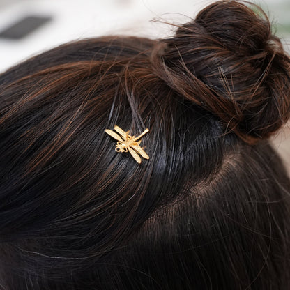 Gold hair clip in a person's hair