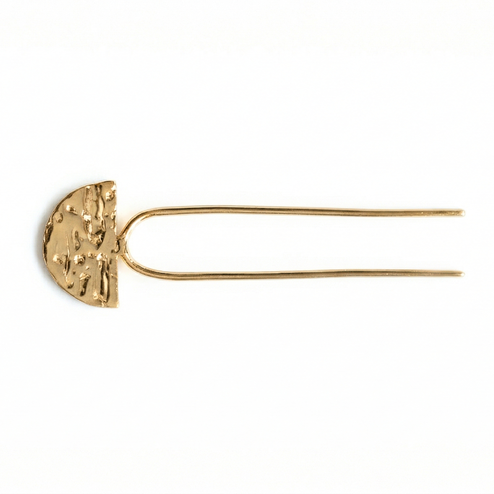 Gold hairpin with textured half-circle design on a white background
