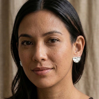 Woman wearing earrings with a neutral background