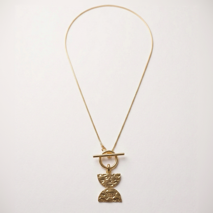 Gold necklace with a Double D pendant on a white background