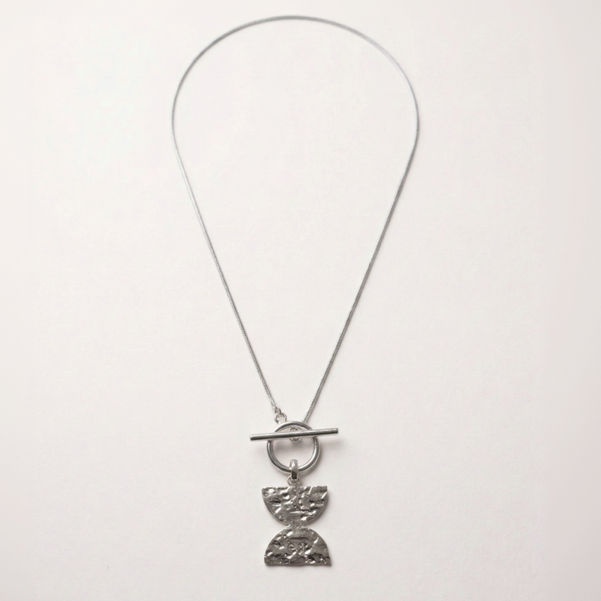 Silver necklace with a unique pendant on a white background