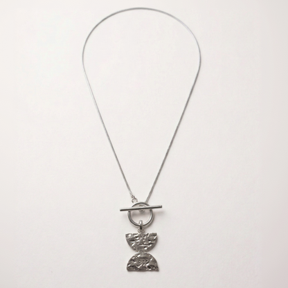 Silver necklace with a unique pendant on a white background