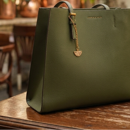 Gold Bag charm on a green handbag