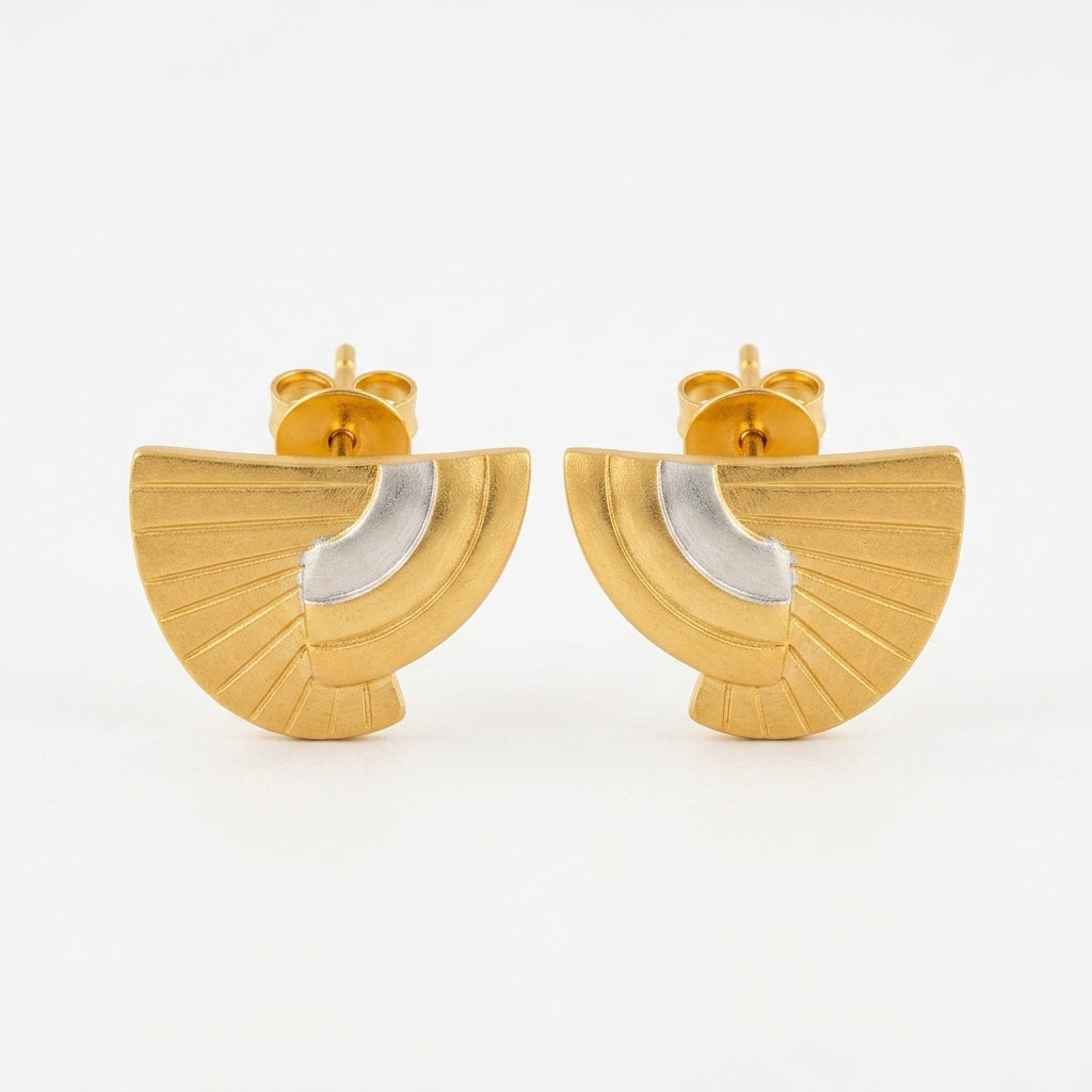 A pair of gold fan-shaped stud earrings with a polished silver crescent inlay, shown against a plain white background.