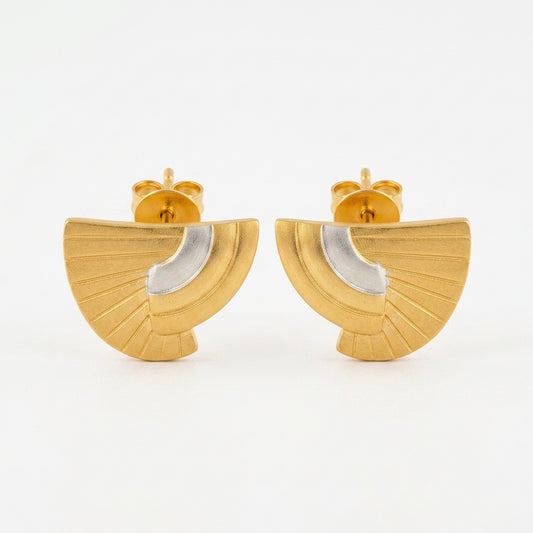 A pair of gold fan-shaped stud earrings with a polished silver crescent inlay, shown against a plain white background.