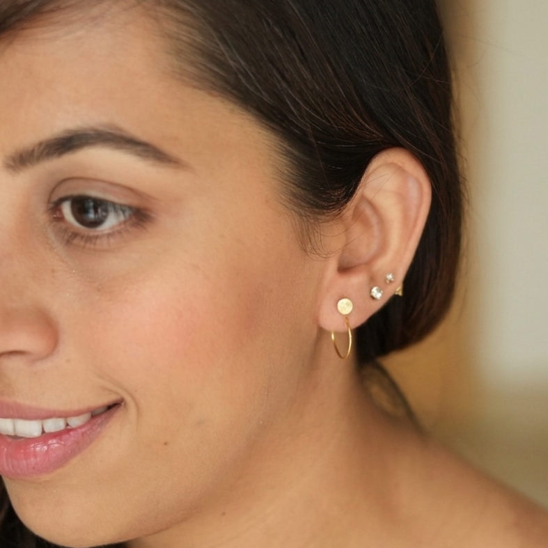 Close-up of a woman wearing earrings with a blurred background