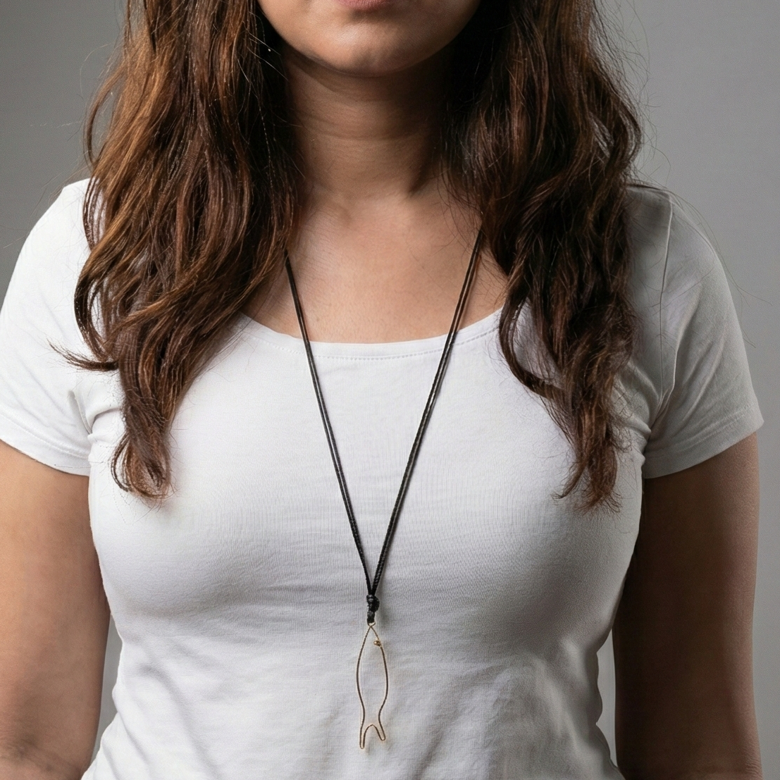 fish pendant on black cord