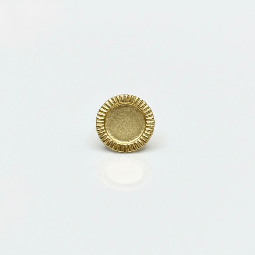 Gold coin brooch on a white background