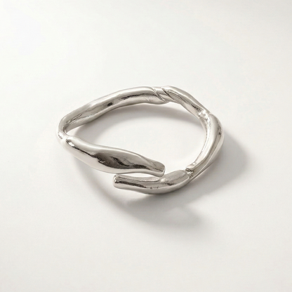 Silver ring with a unique design on a light gray background