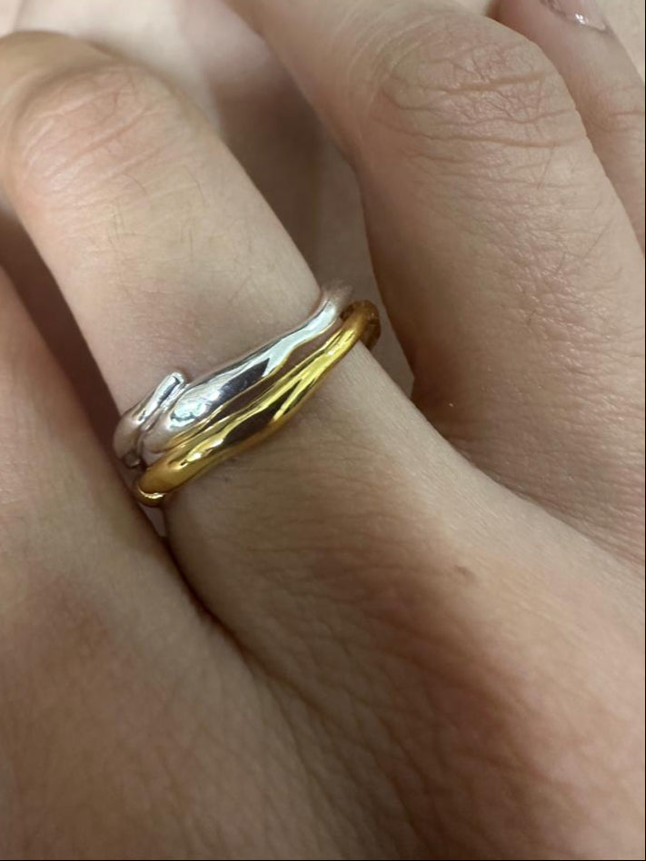 Gold ring on a finger with a blurred background