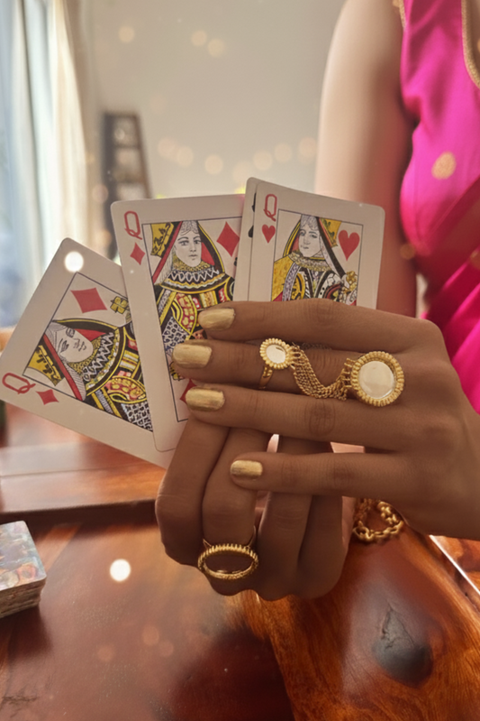 Hand holding playing cards with a blurred background