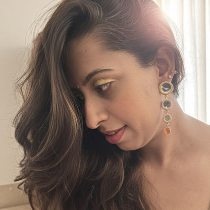 Woman with long wavy hair wearing dangler earrings 