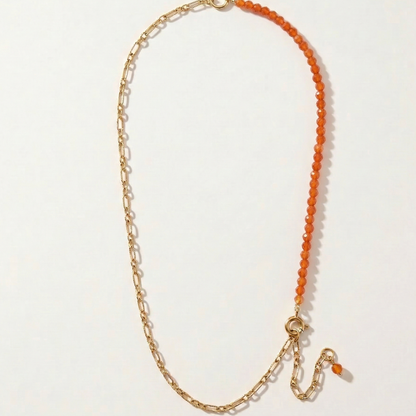 Necklace with carnelian semi-precious stones and gold chain on a light gray background