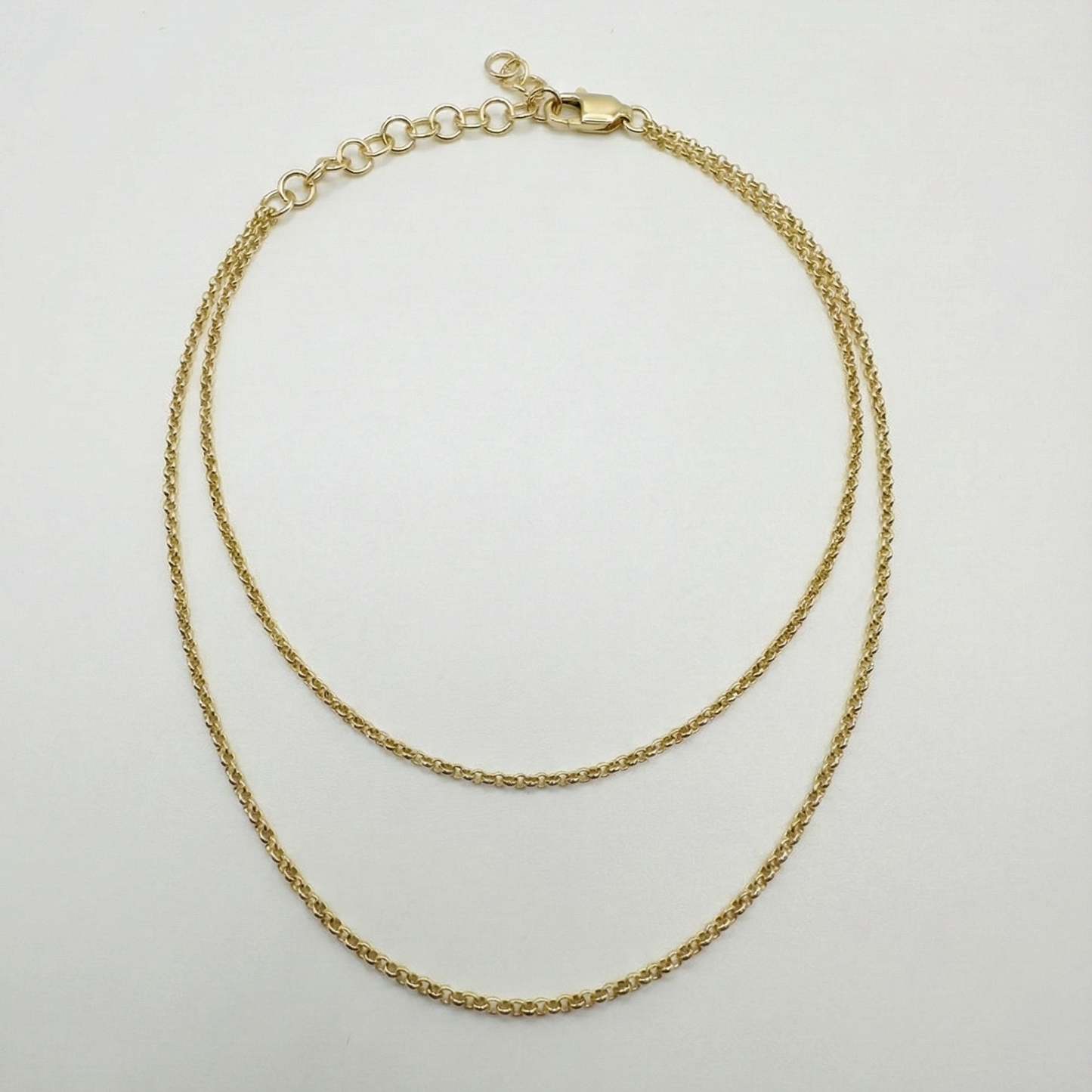 Gold anklet necklace on a light gray background