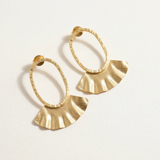 Gold hoop earrings with fan-shaped ends on a light background