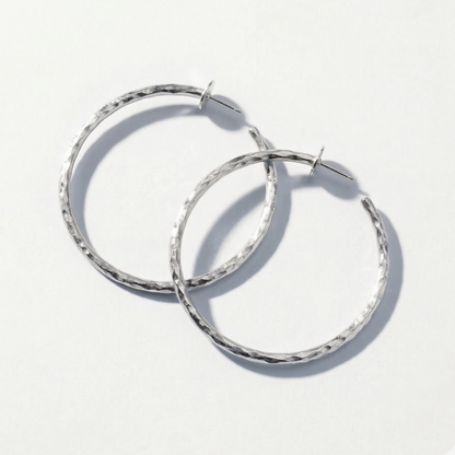 Pair of silver hoop earrings on a white background