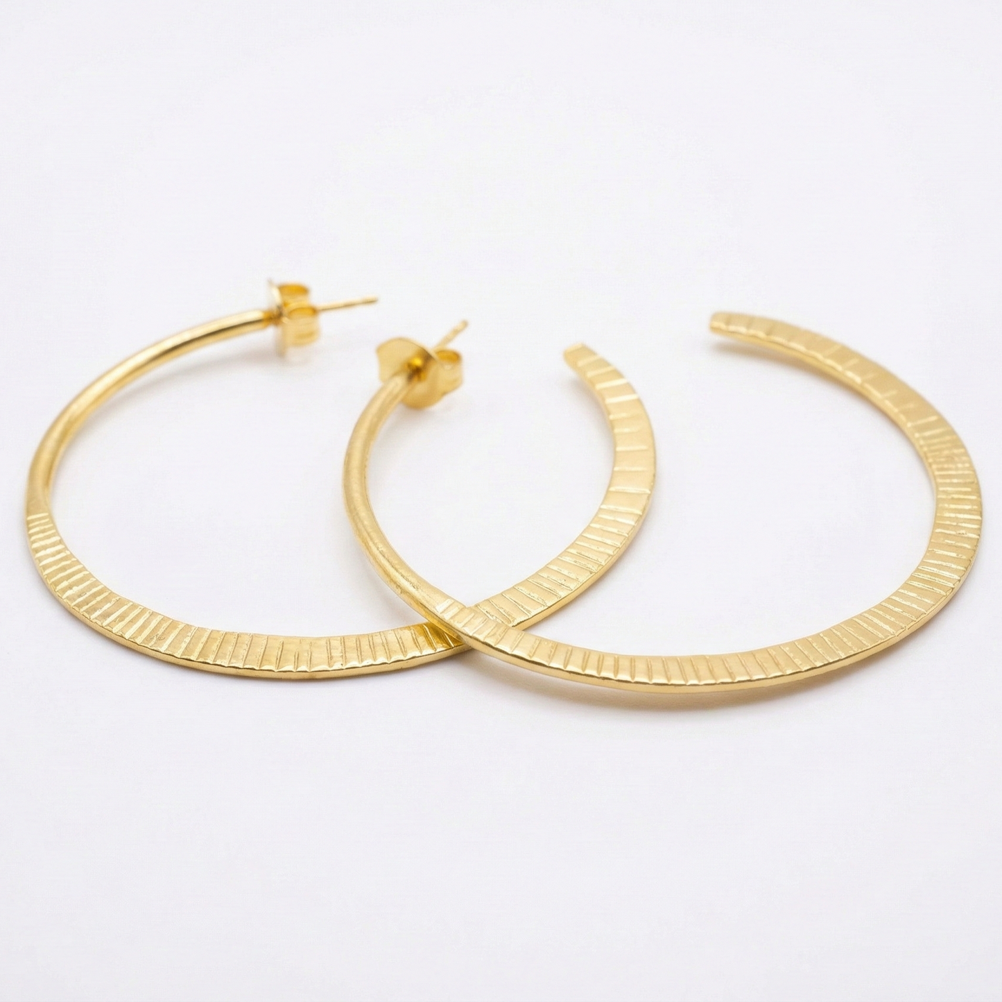 Gold hoop earrings on a white background