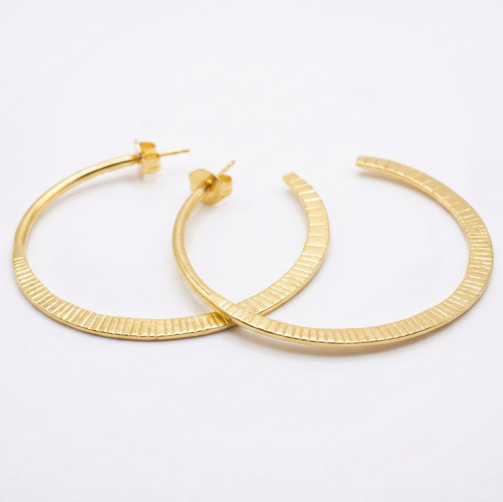 Gold hoop earrings on a white background
