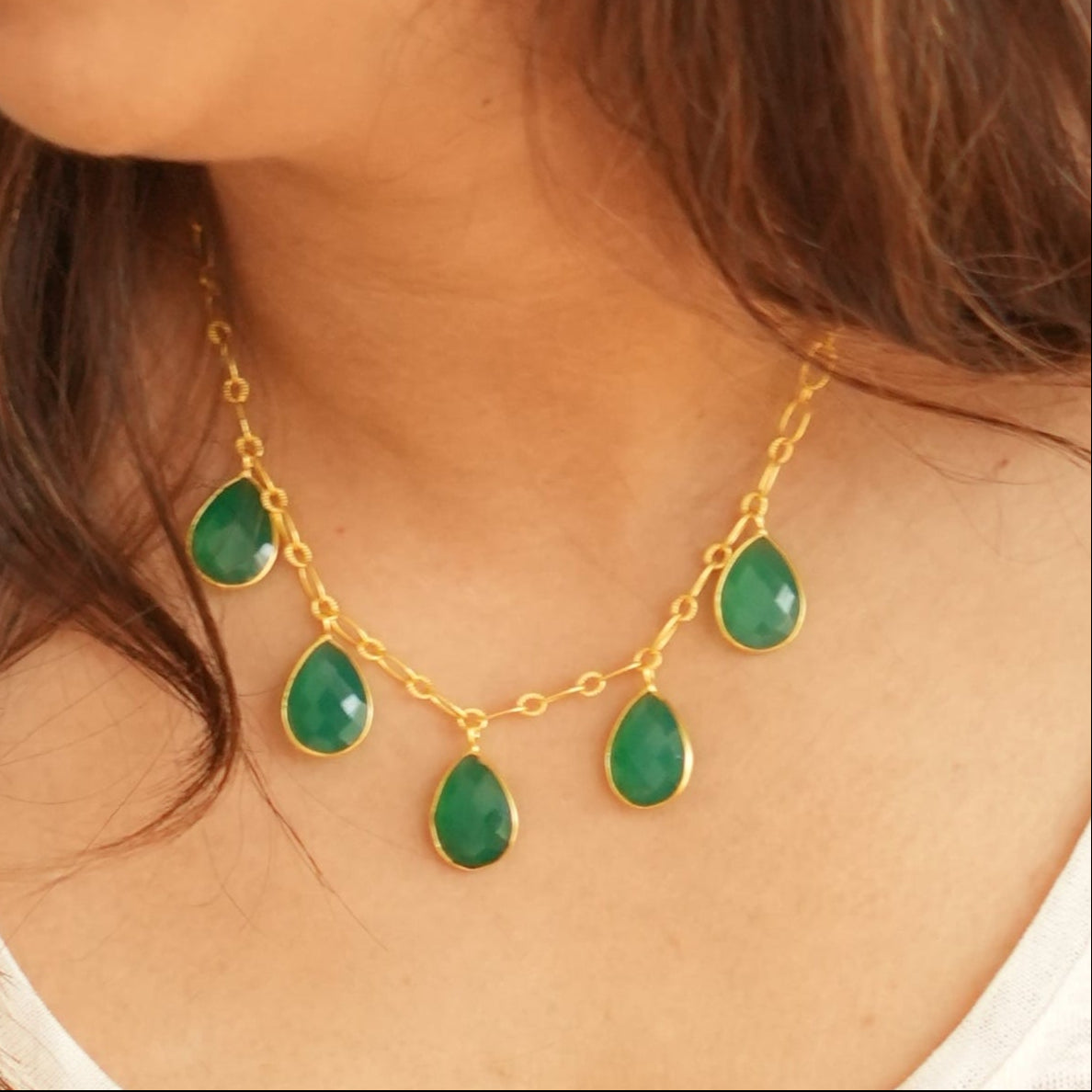 Woman wearing green onyx necklace