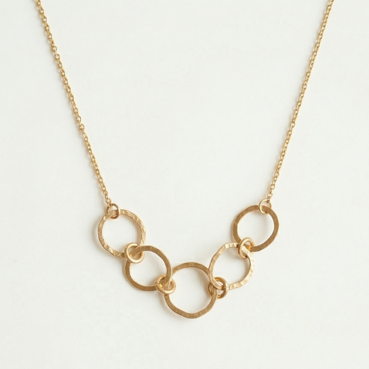 Gold chain necklace on a light gray background