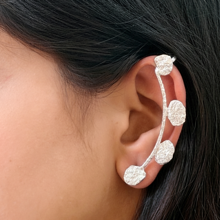 Silver earclimber worn by a person with dark hair.