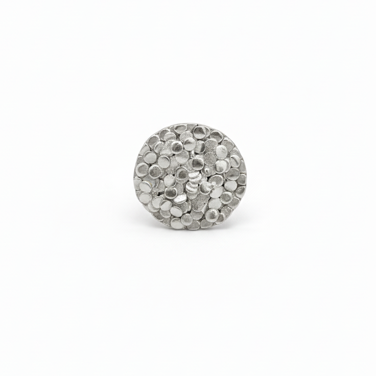 Silver ring charm on a white background