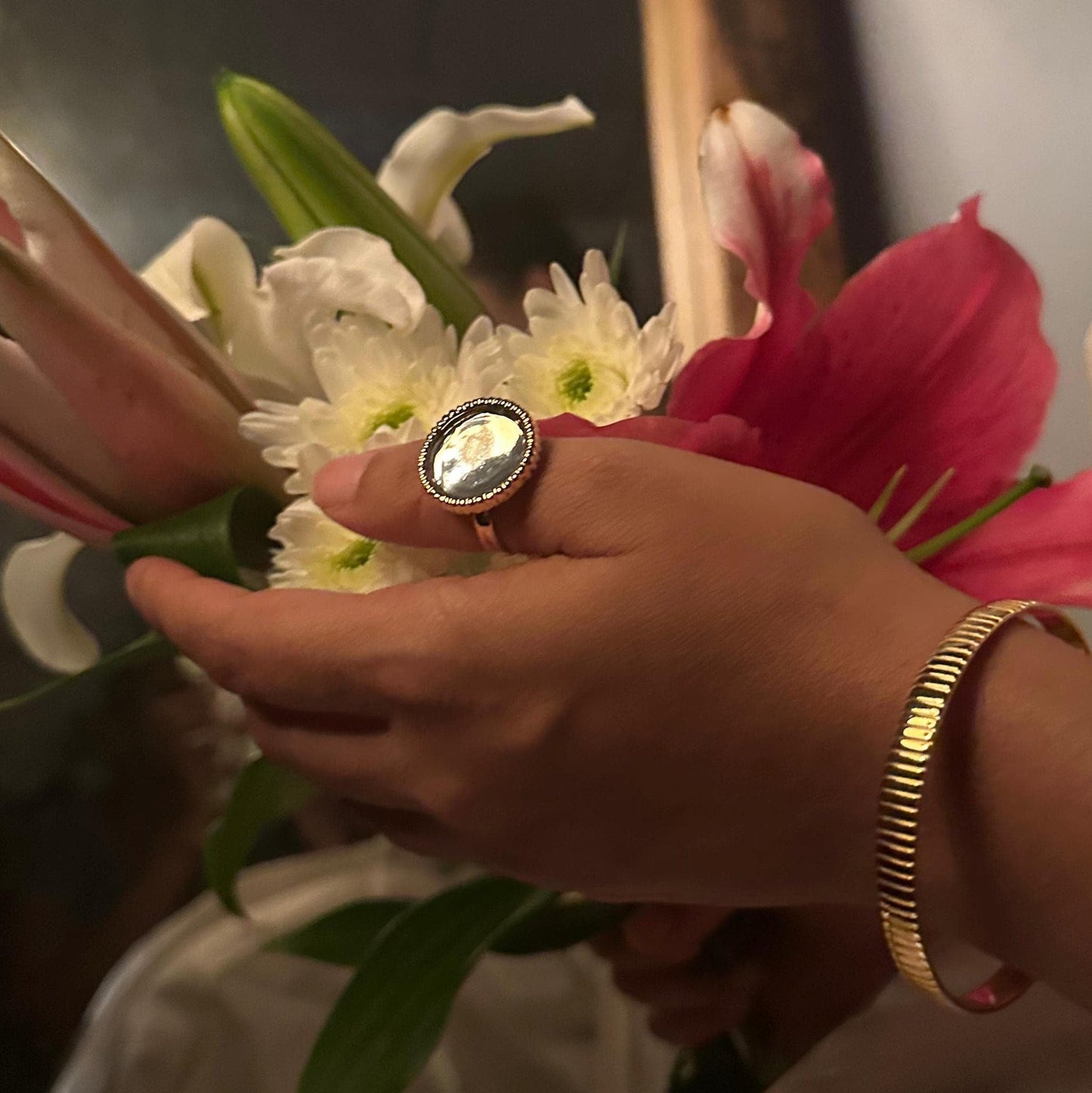 Person holding a bouquet of flowers with a blurred background