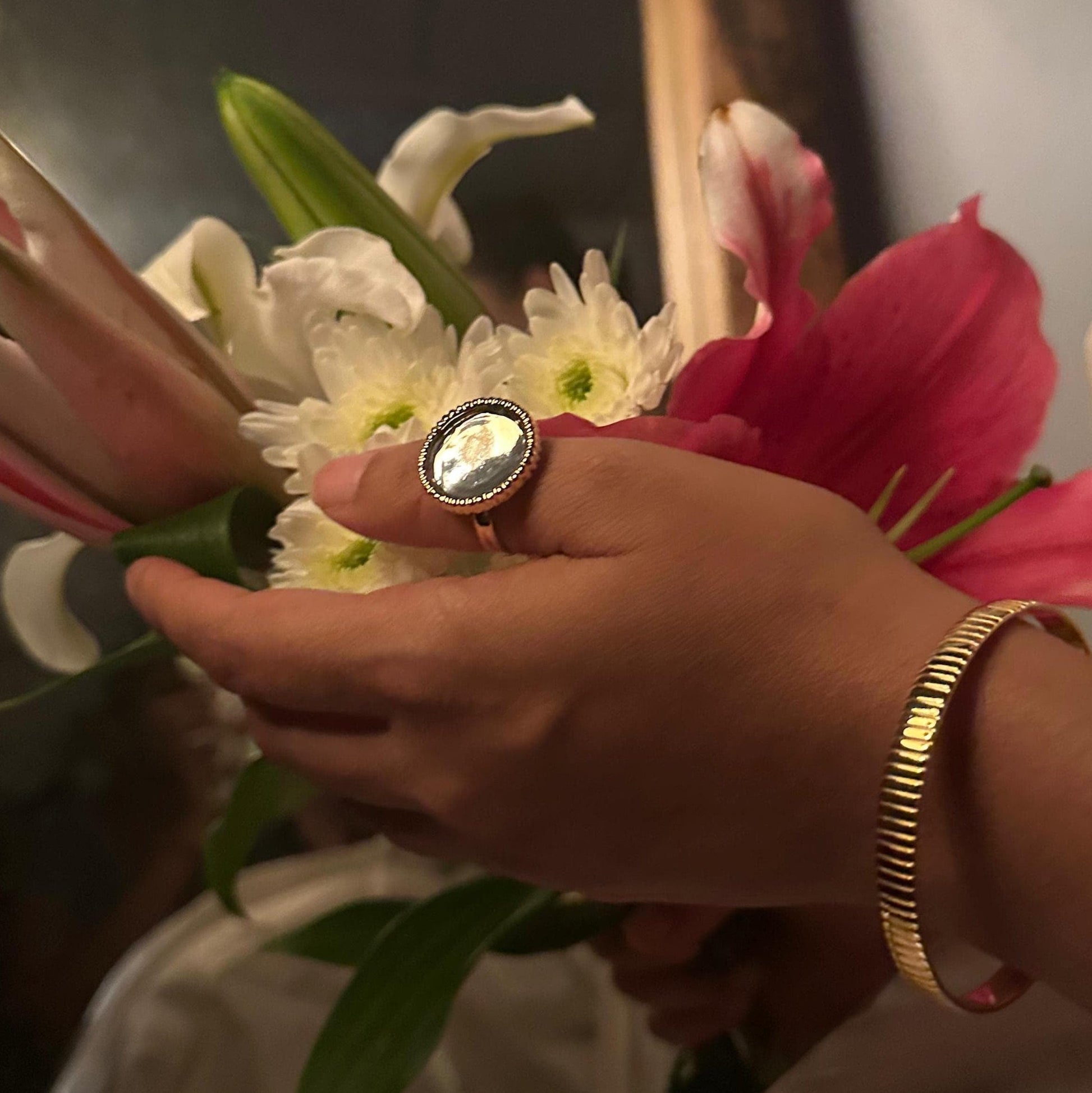 Person holding a bouquet of flowers with a blurred background