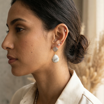Woman wearing earrings with a neutral background