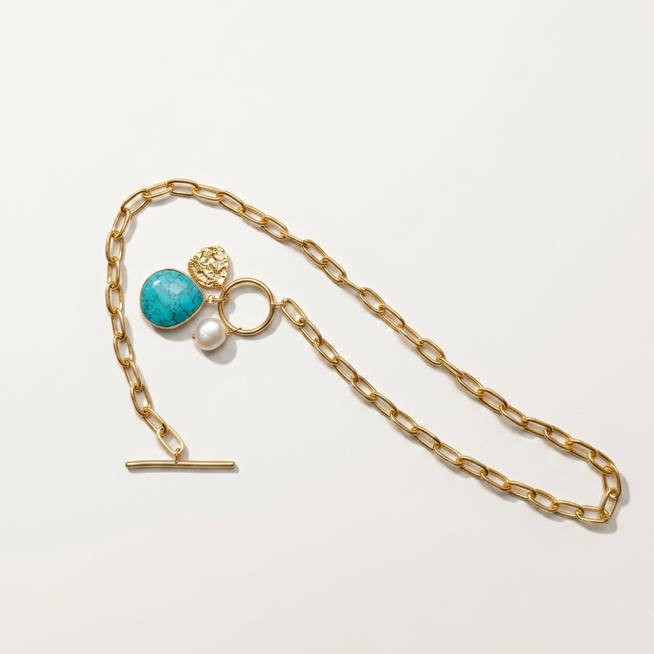 paperclip toggle charm necklace with gold textured coin, freshwater pearl, turquoise stone