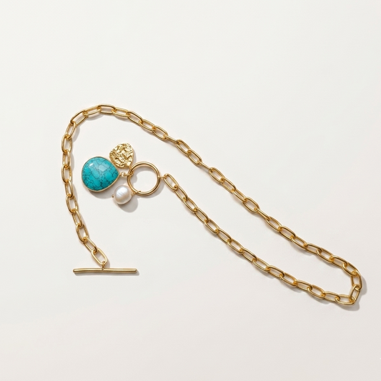 paperclip toggle charm necklace with gold textured coin, freshwater pearl, turquoise stone