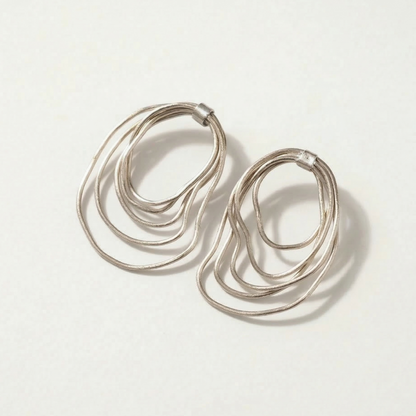 Silver hoop earrings on a light gray background